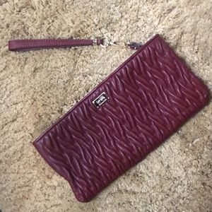 coach zipper clutch. Embossed gorgeous design . Like new never carried.